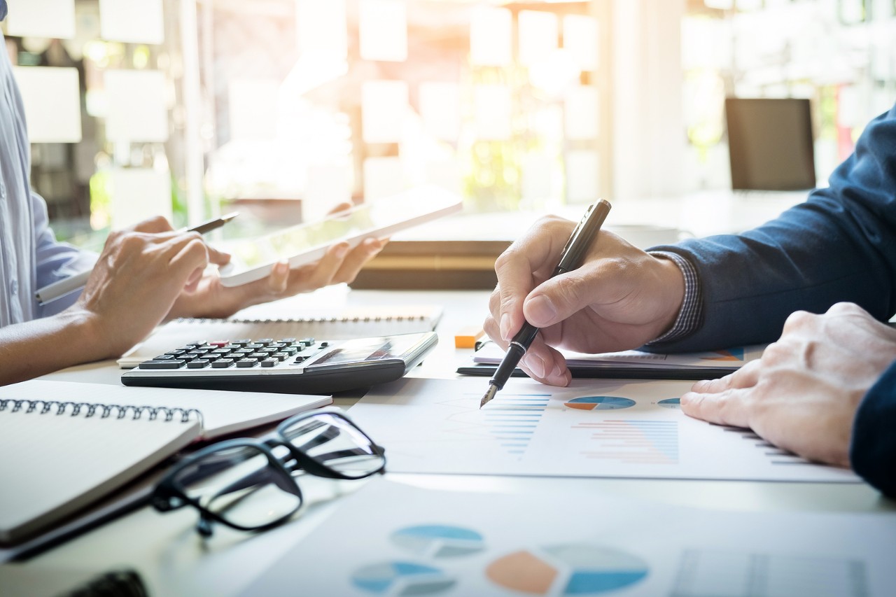 Business Man Financial Inspector And Secretary Making Report, Calculating Or Checking Balance. Inter business man financial inspector and secretary making report calculating or checking balance. Internal Revenue Service inspector checking document. Audit concept