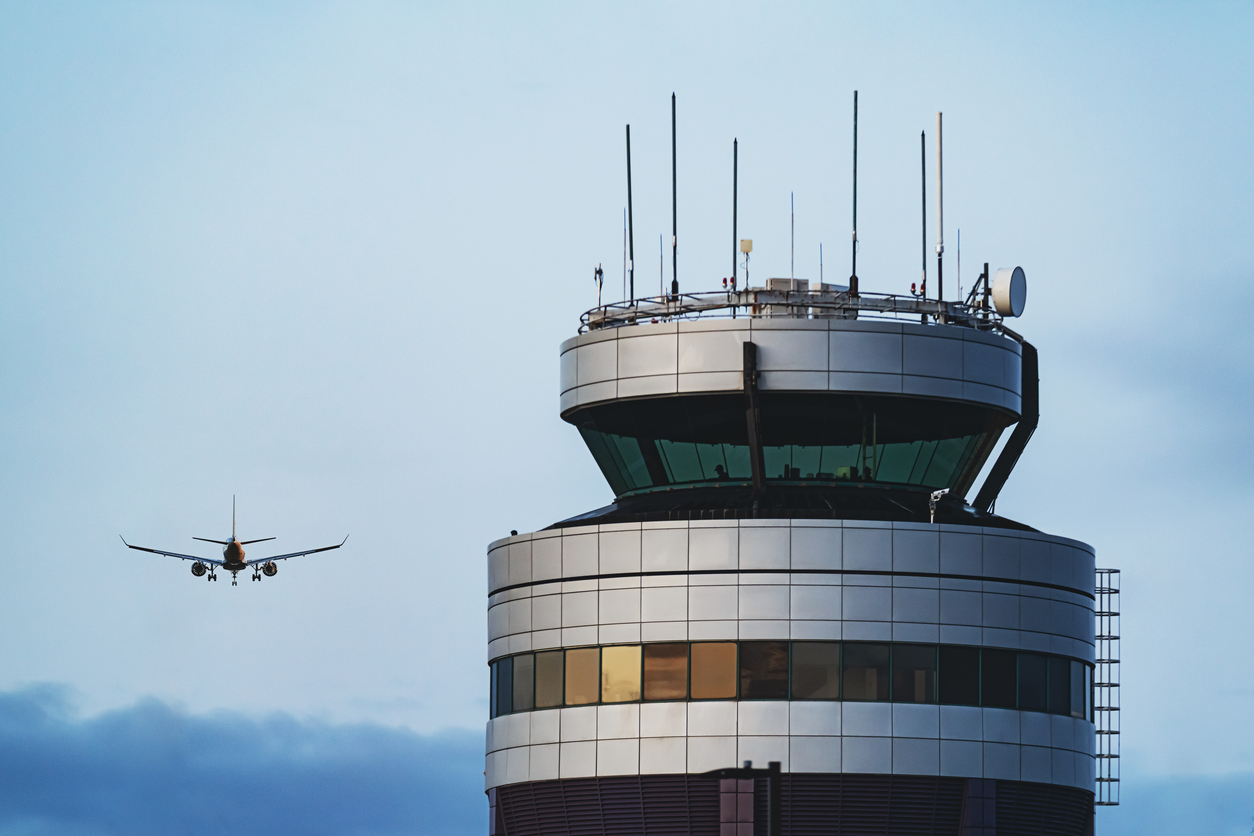 Airport control tower in evening light. Composite image.